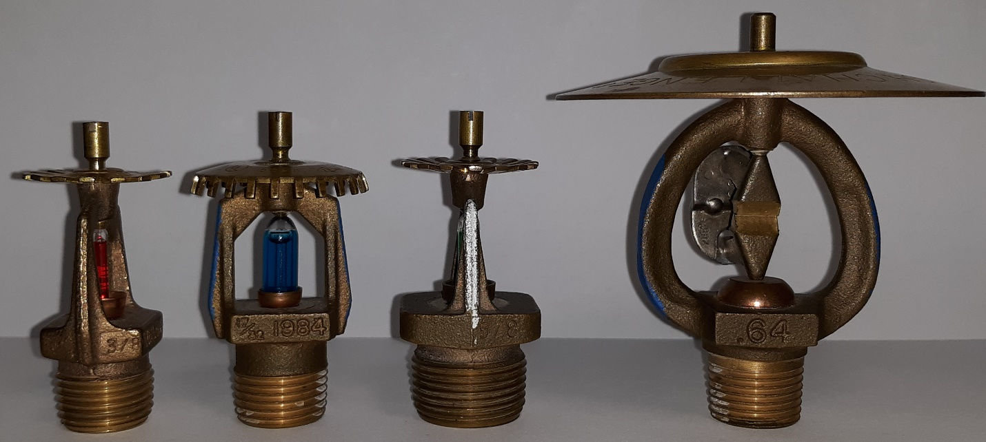 Four fire sprinklers manufactured before 2001 showing pintles and orifice size frame markings